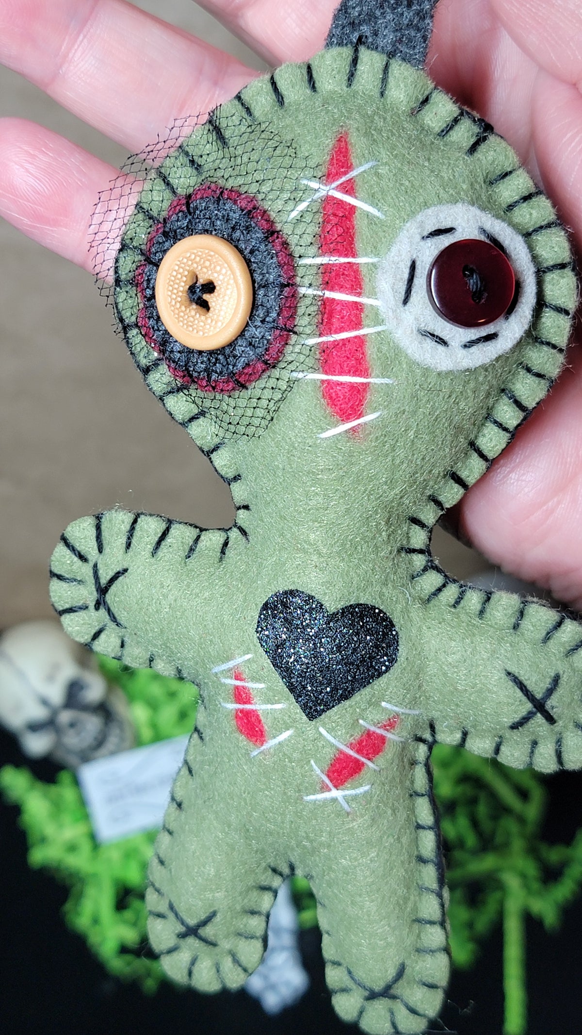 Olive green Button-Eyed Stitchling felt keychain and bag charm, ready to ship