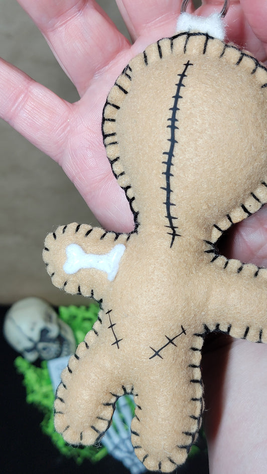 Hand-stitched Button-Eyed Stitchling bag charm with a red heart