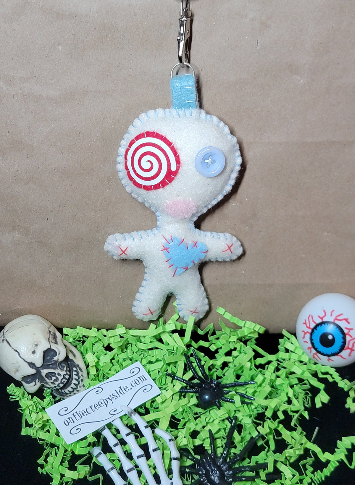 Baby blue Button-Eyed Stitchling felt plush keychain with metal keyring
