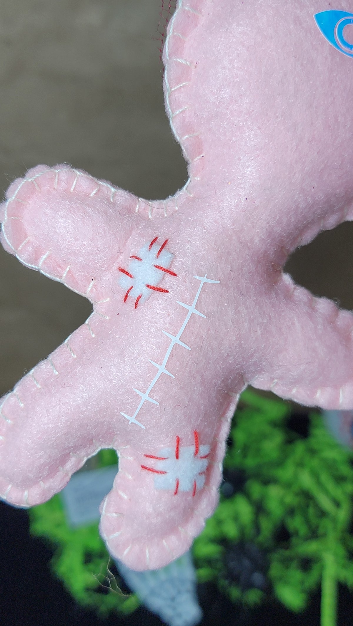 Baby pink Button-Eyed Stitchling plush keychain with handmade details