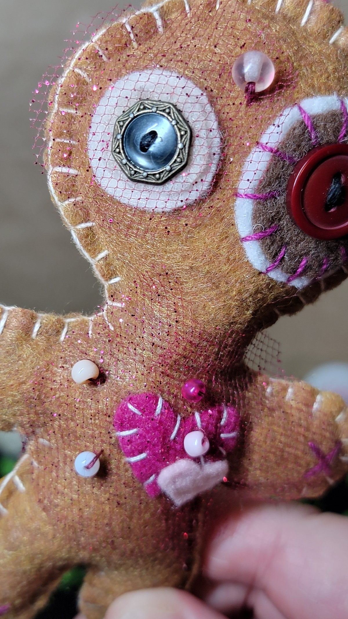 Brown and pink Mini Stitchling plush body with its metal keyring attachment