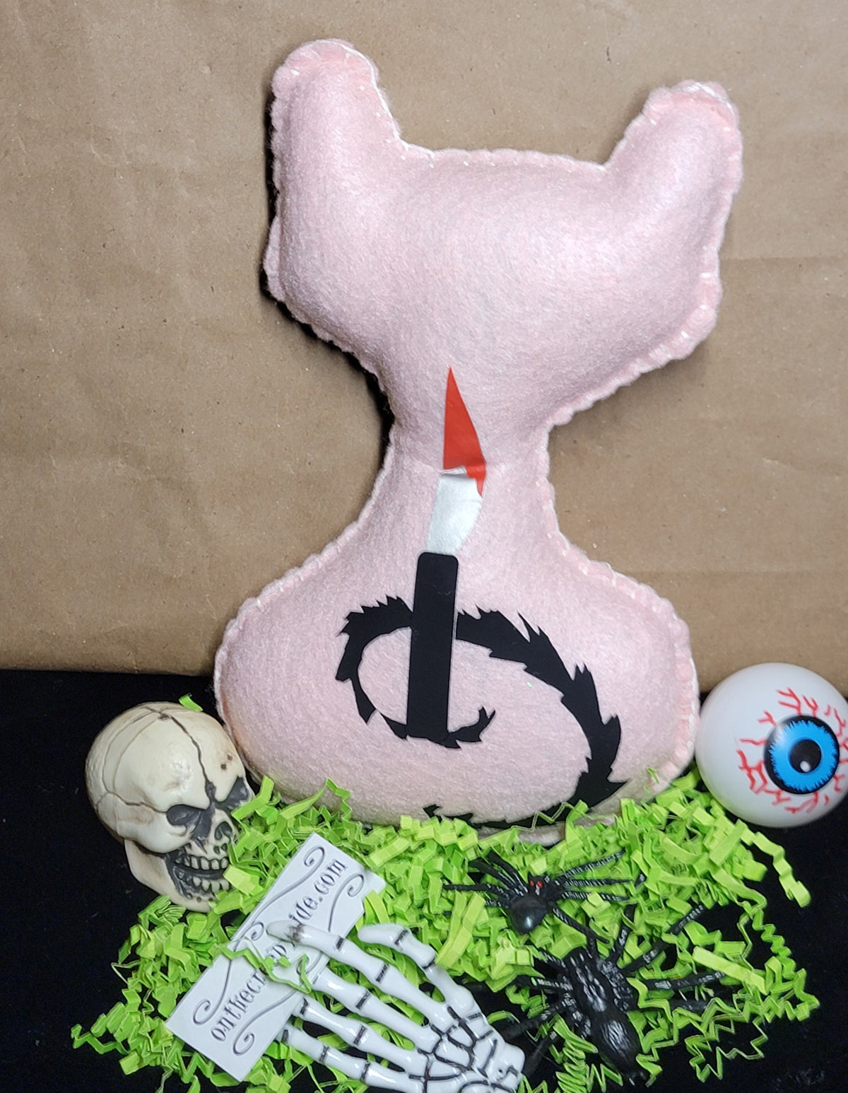 Creepy-cute baby pink cat plush with hand-stitched details