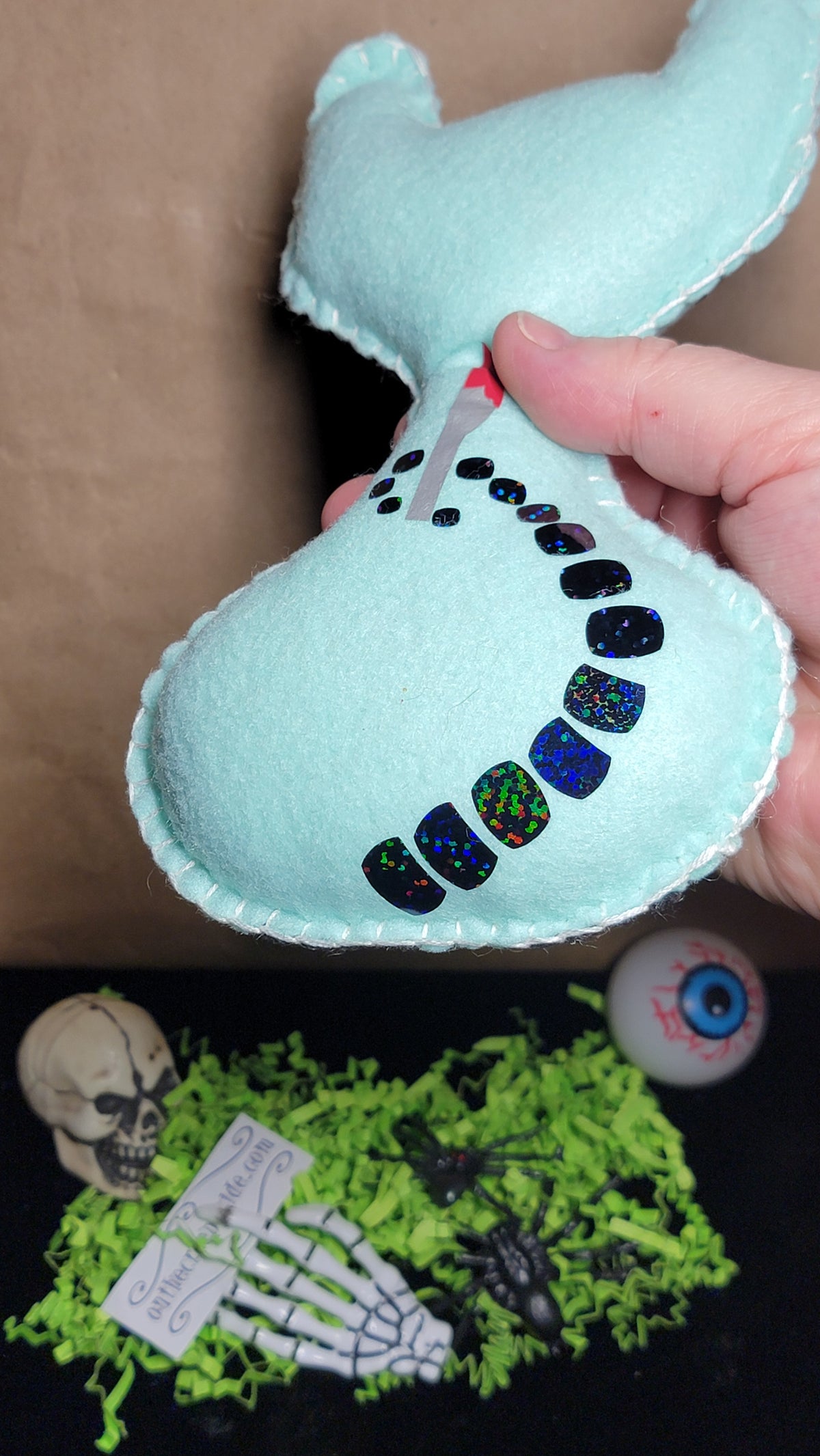 Hand-stitched mint green killer kitty plush with creepy-cute style