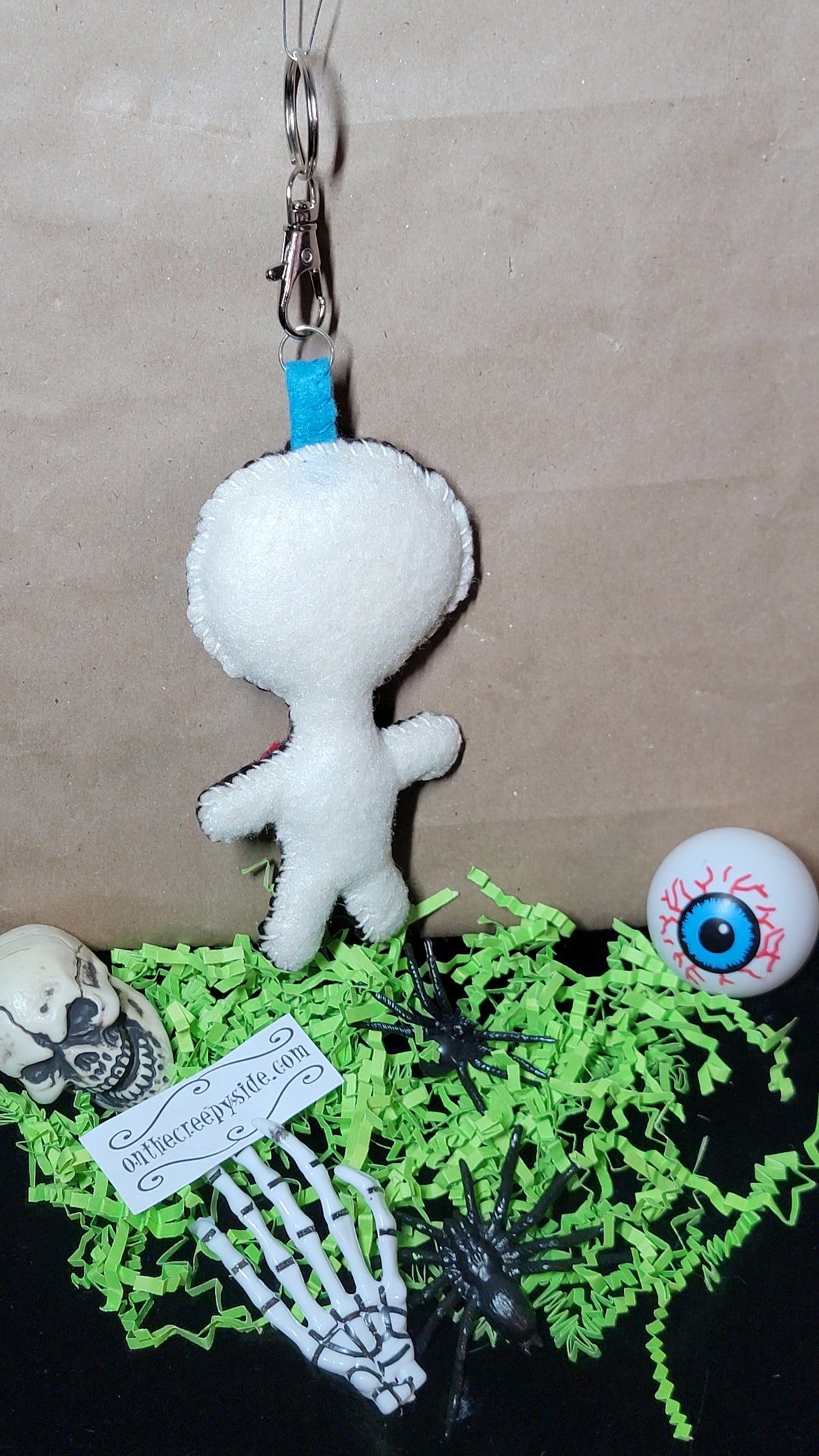 Creepy-cute Button-Eyed Stitchling felt keychain, ready to ship