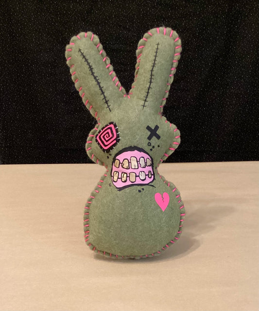 Olive Green Zombie bunny plush holding a sledgehammer behind its back