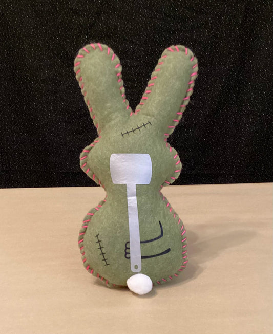 Olive Green Zombie bunny plush holding a sledgehammer behind its back