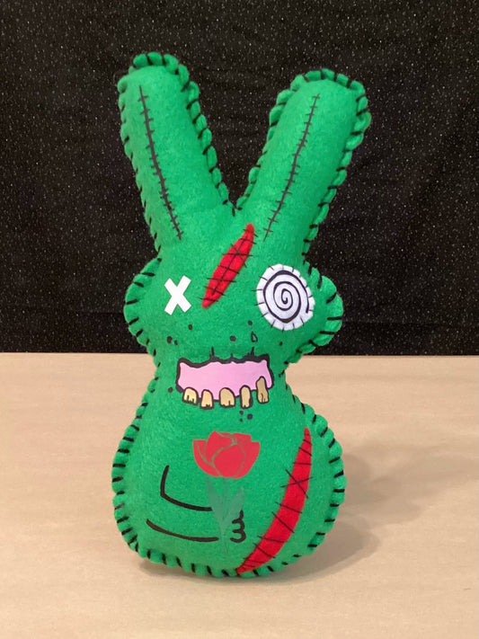 Creepy Green Zombie bunny plush holding a flower and a sledgehammer