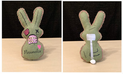 Olive Green Zombie bunny plush holding a sledgehammer behind its back