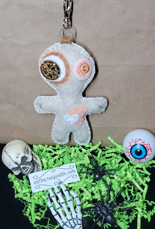 Hand-stitched felt Button-Eyed Stitchling plush keychain with metal keyring