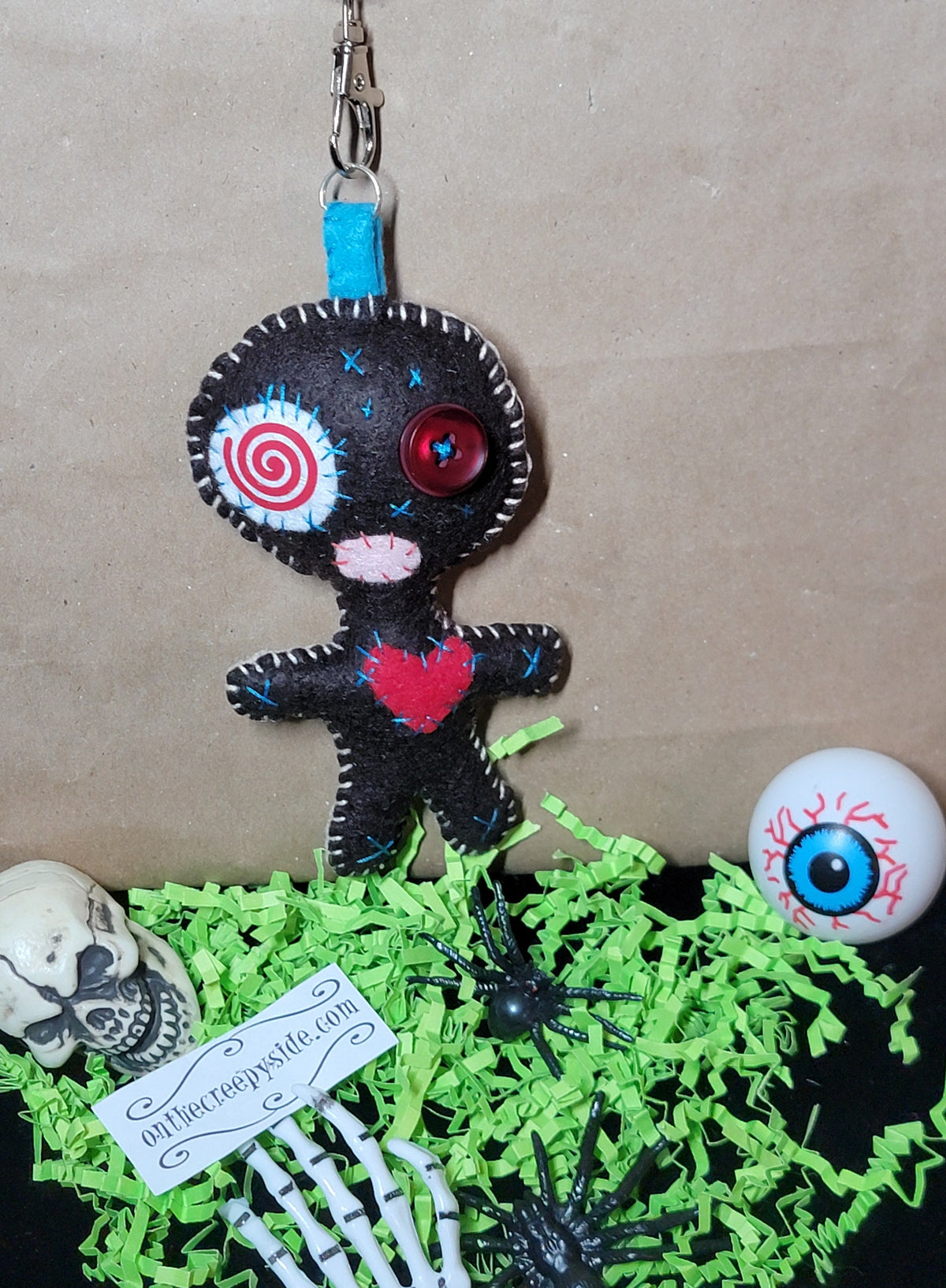 Hand-stitched felt Button-Eyed Stitchling plush keychain with metal keyring