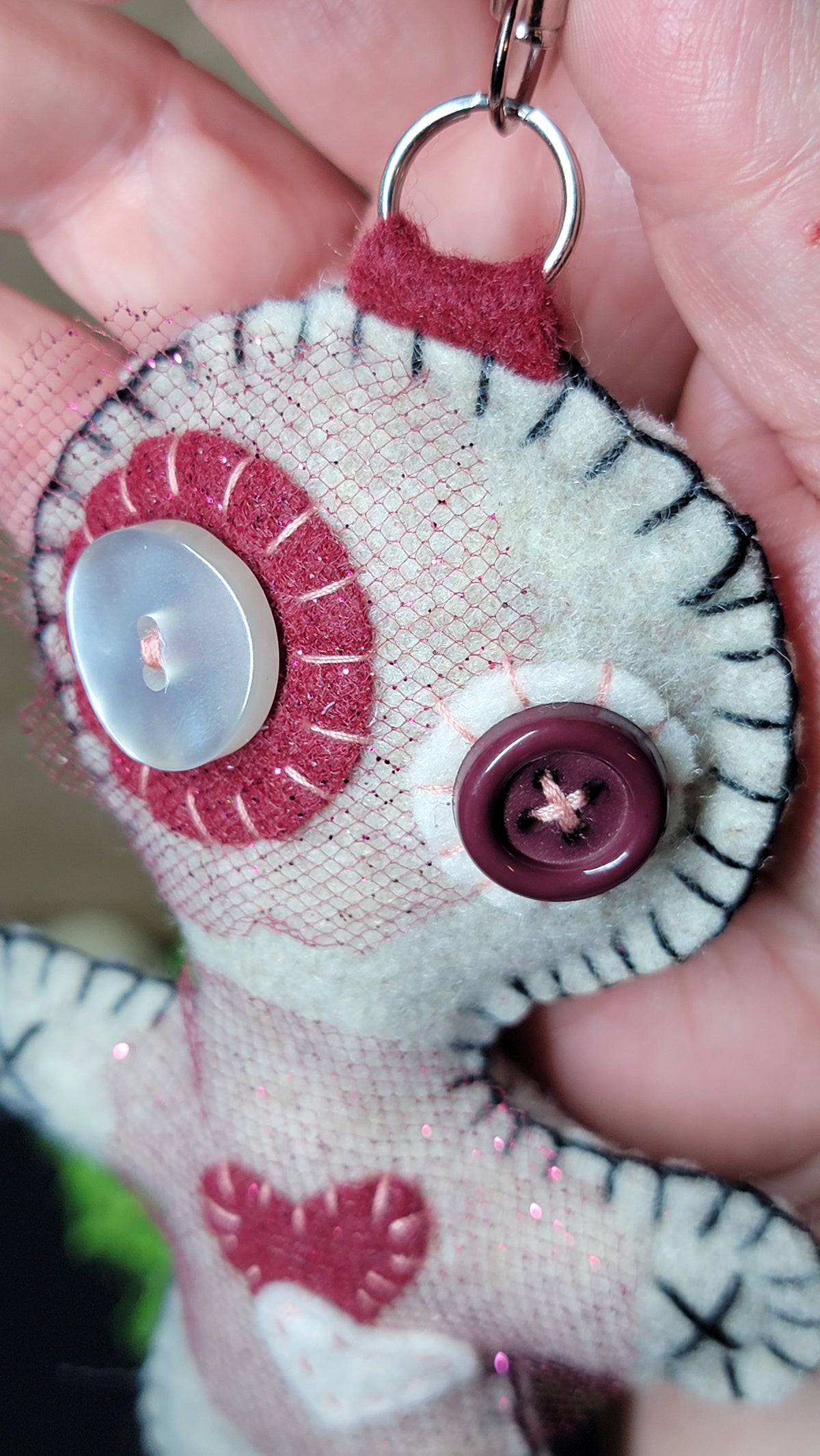 One-of-a-kind Mini Button-Eyed Stitchling keychain shown ready to ship⠋