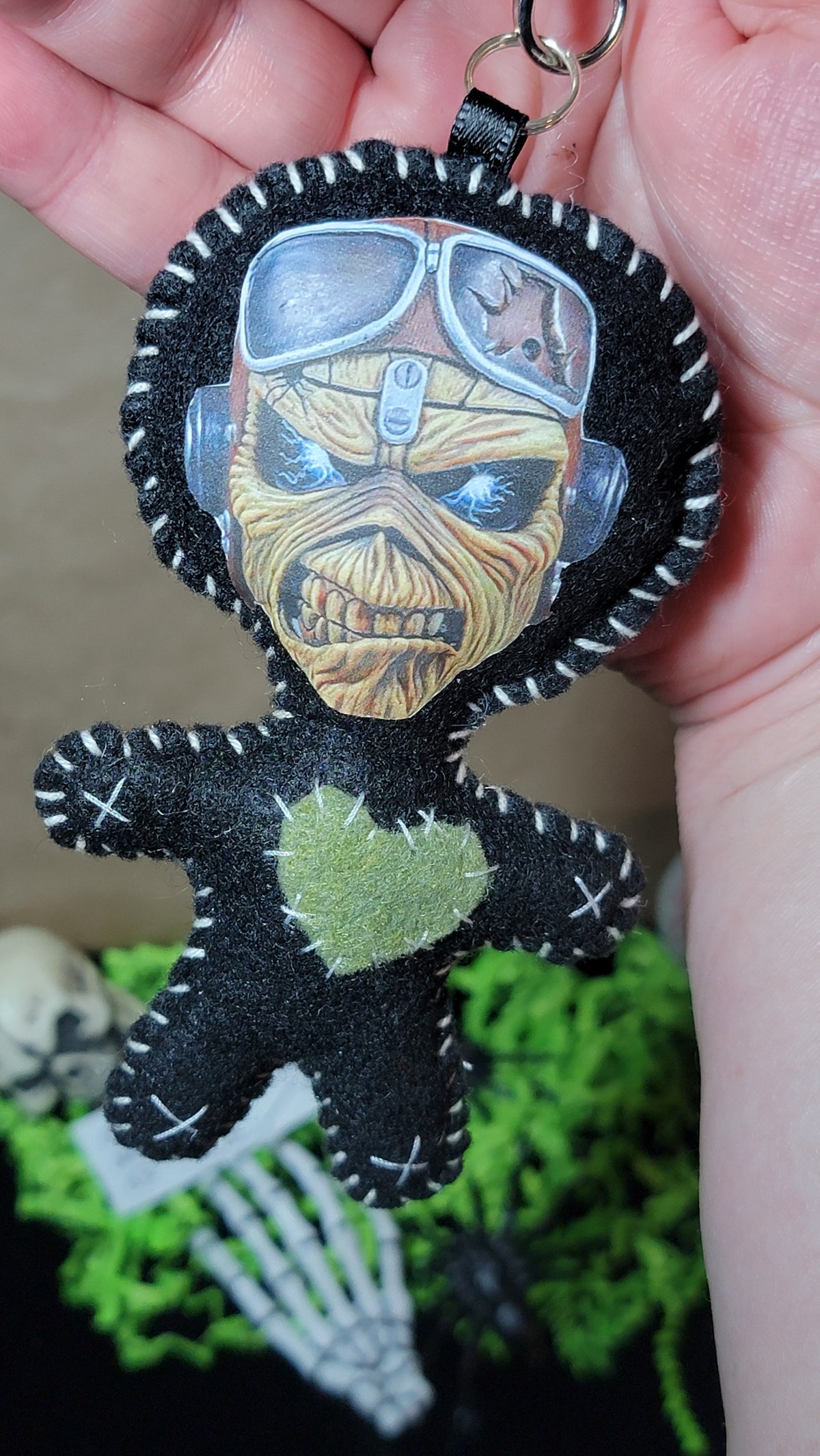  Close-up of handmade Aviator Eddie Stitchling felt keychain showing pilot goggles, detailed face, and green heart