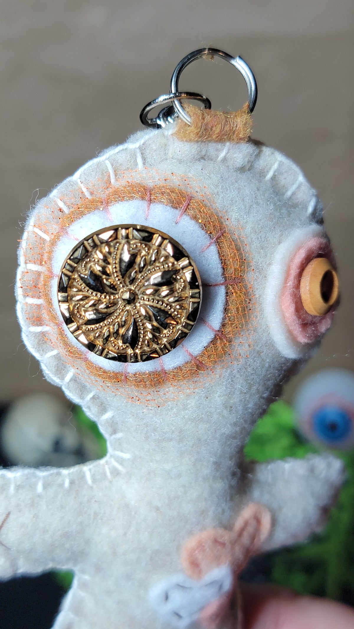 Creepy-cute Button-Eyed Stitchling felt keychain with handmade details