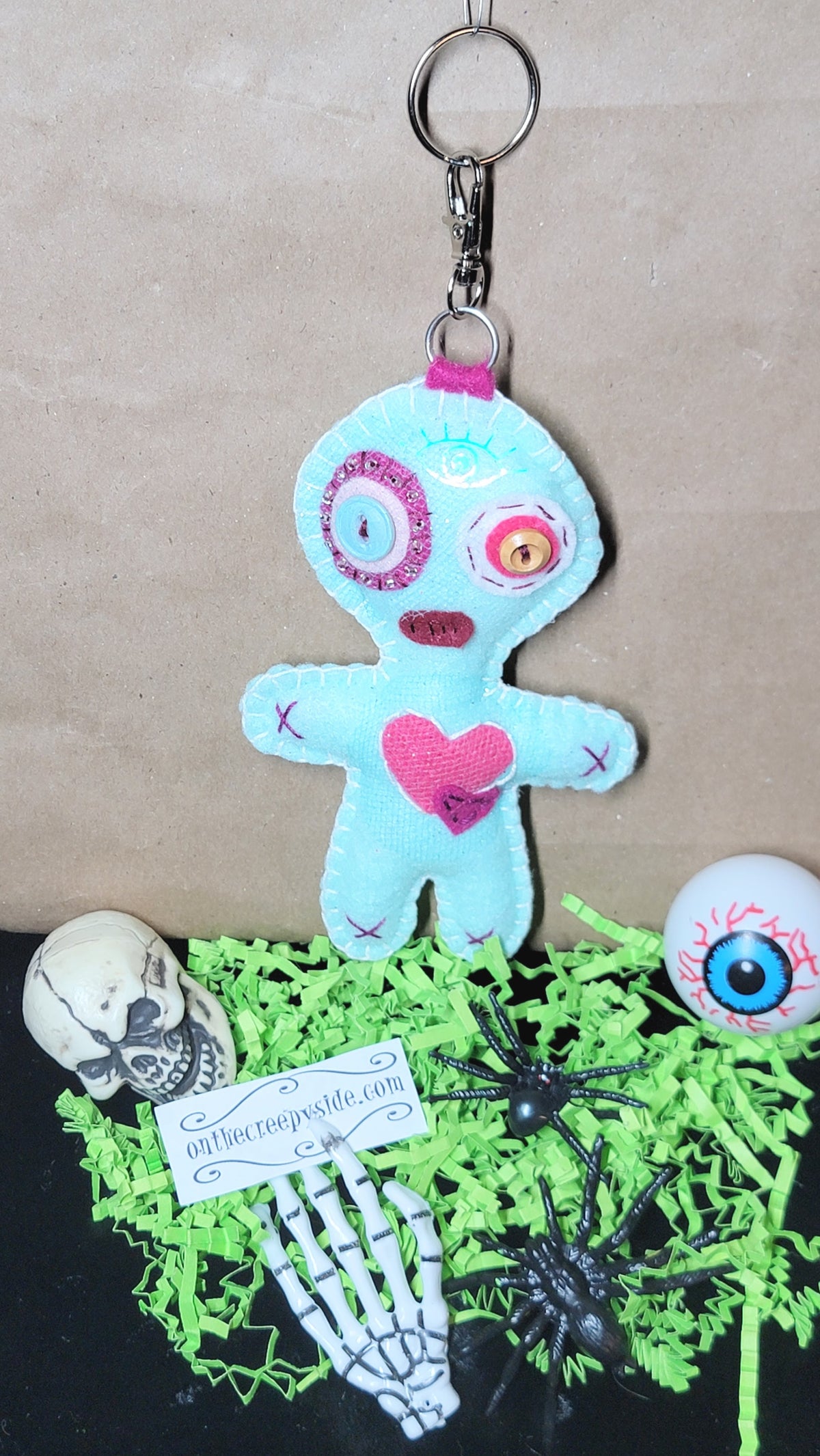 Mint green Button-Eyed Stitchling felt plush keychain with metal keyring