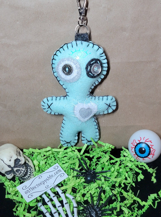 Mint green and grey Button-Eyed Stitchling felt plush keychain with metal keyring