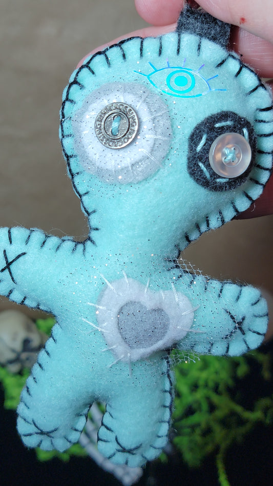 Hand-stitched mint green and grey Button-Eyed Stitchling bag charm