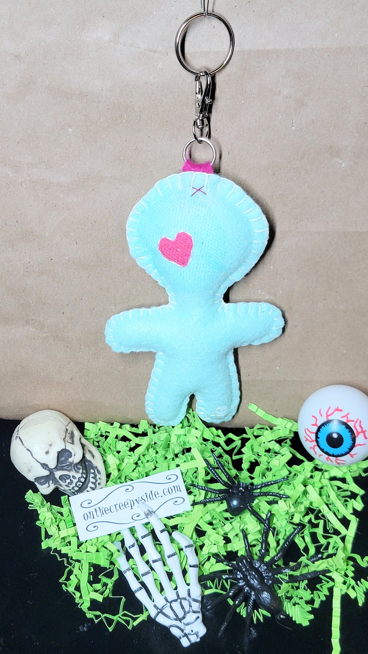 Hand-stitched mint green Button-Eyed Stitchling bag charm