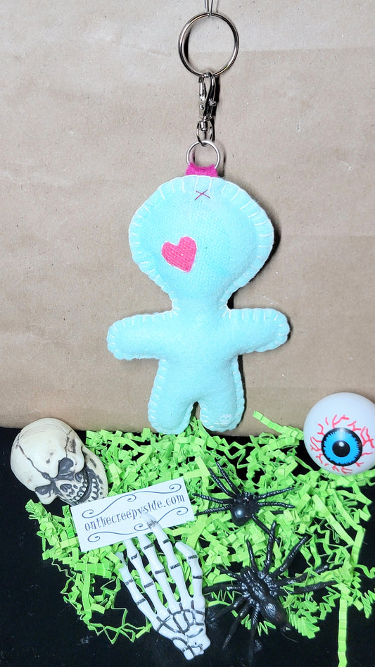 Hand-stitched mint green Button-Eyed Stitchling bag charm