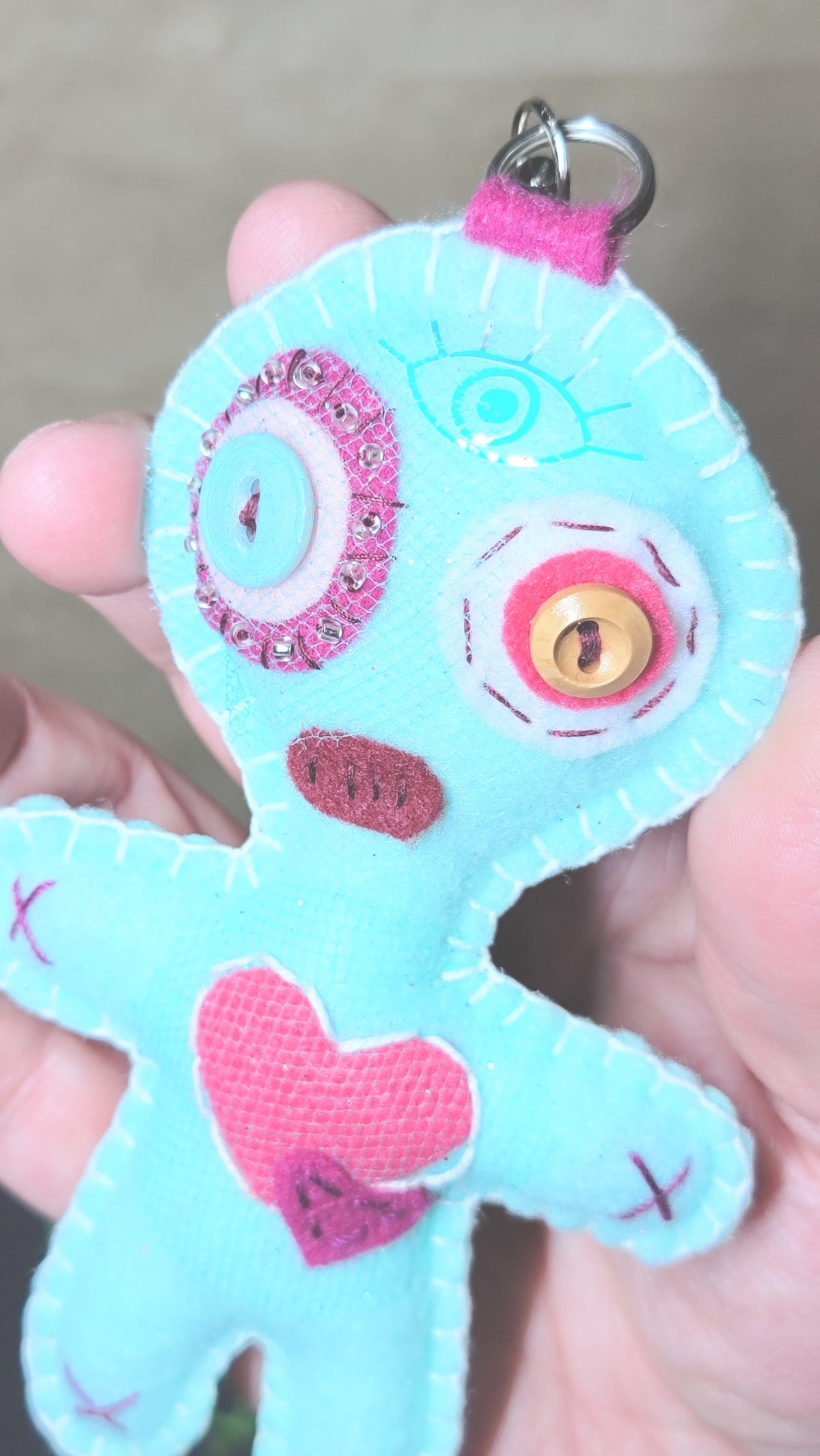 Mint green Button-Eyed Stitchling felt keychain and bag charm, ready to ship