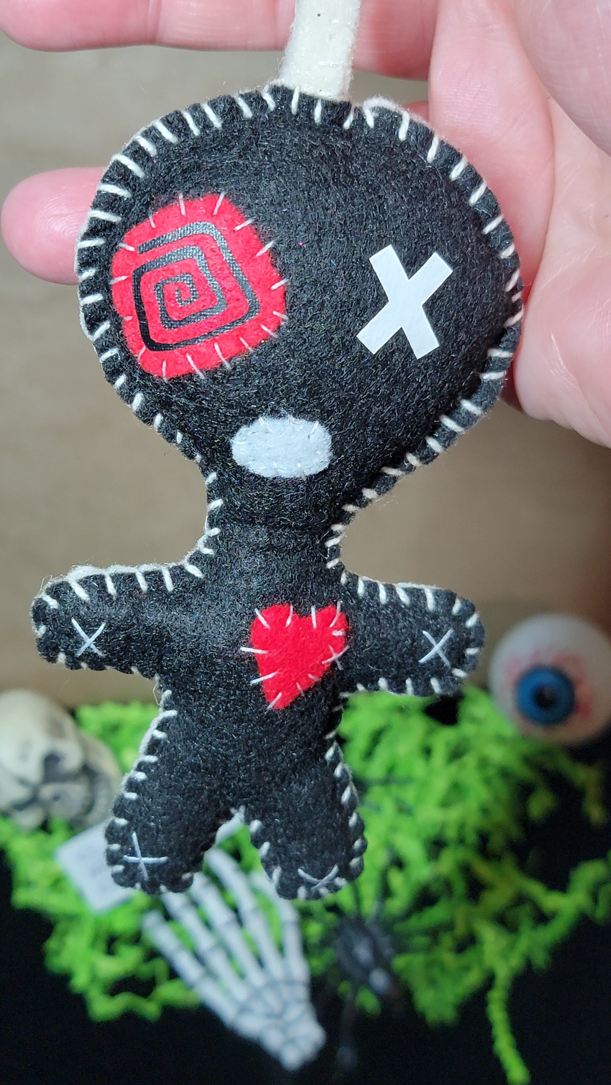 Black handmade felt Stitchling keychain with creepy-cute details, ready to ship