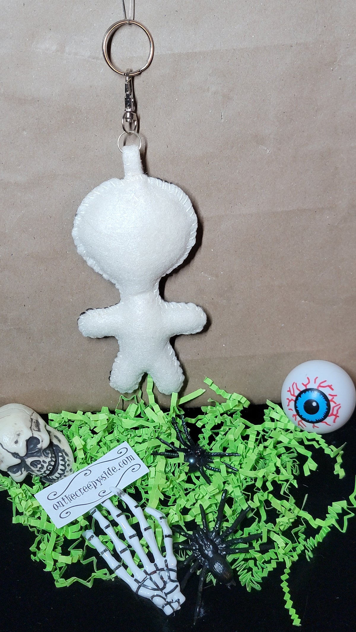 One-of-a-kind black Button-Eyed Stitchling handmade felt bag charm