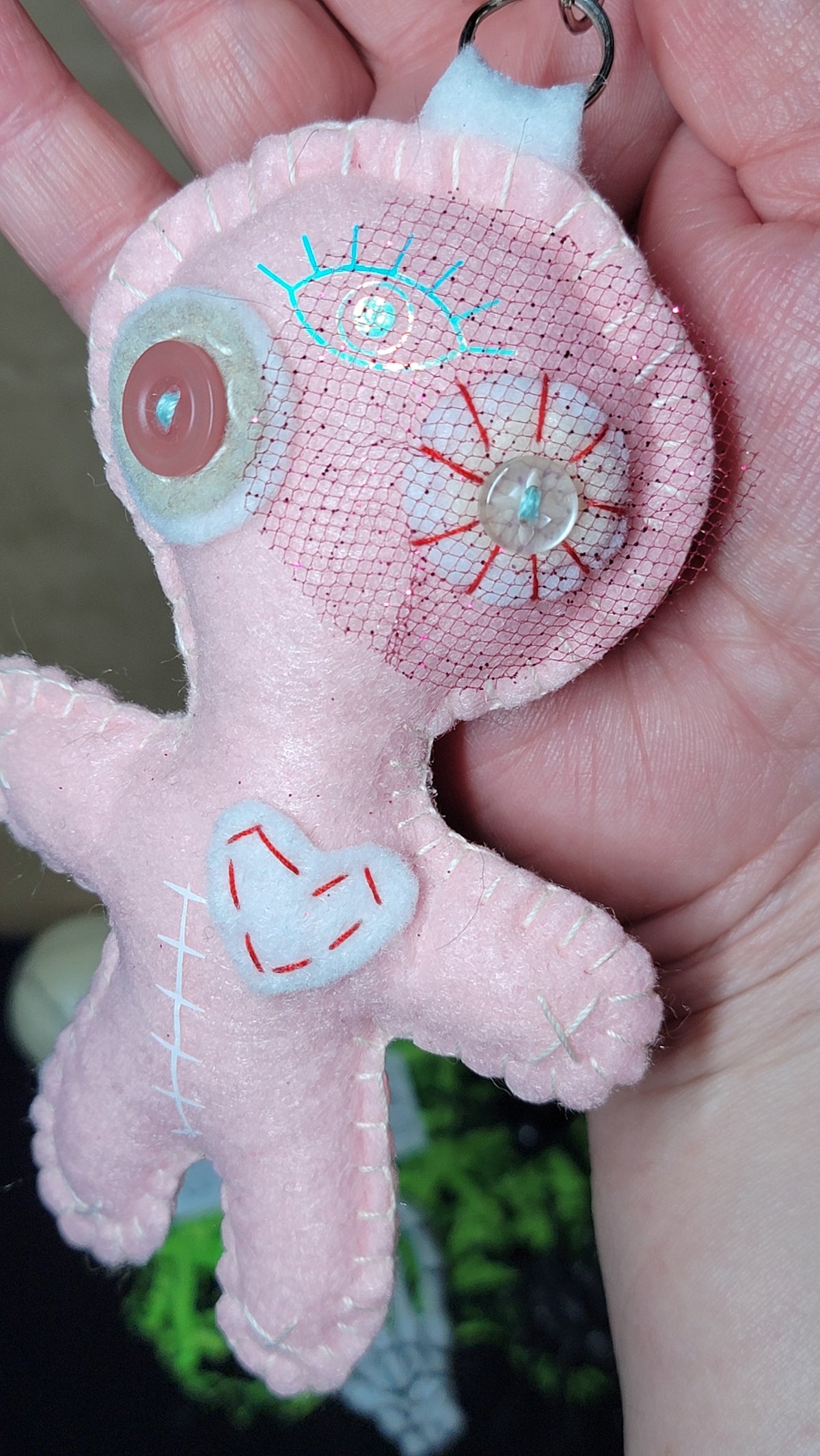 One-of-a-kind baby pink felt Stitchling with button eyes