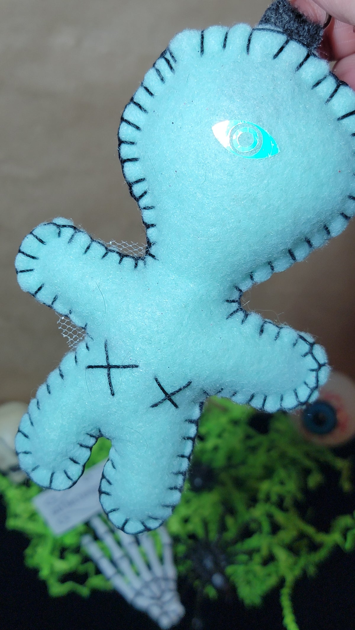 One-of-a-kind mint green and grey felt Stitchling with button eyes