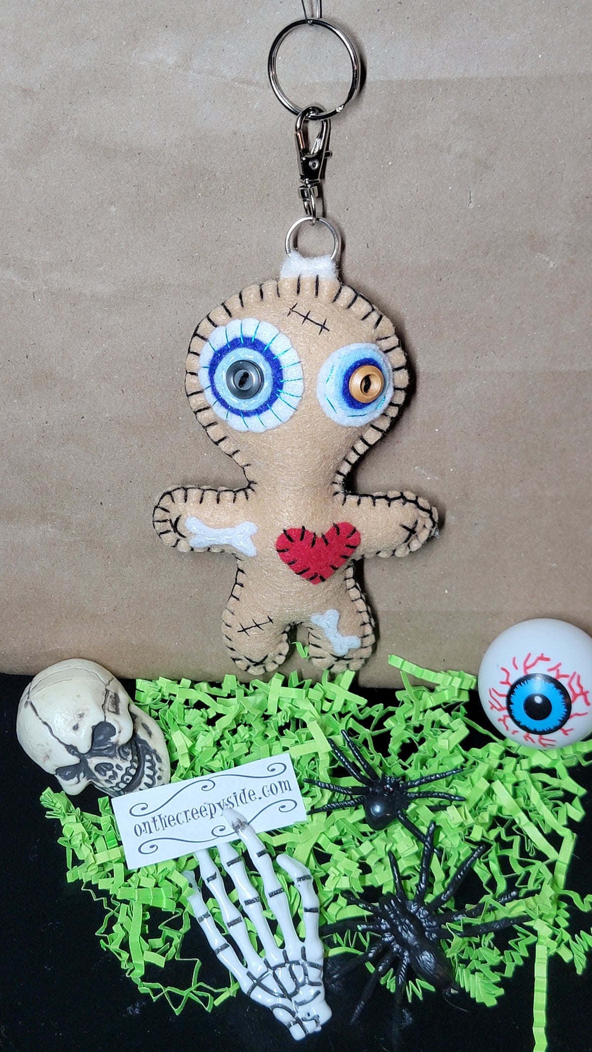 One-of-a-kind felt Stitchling with button eyes and red heart detail