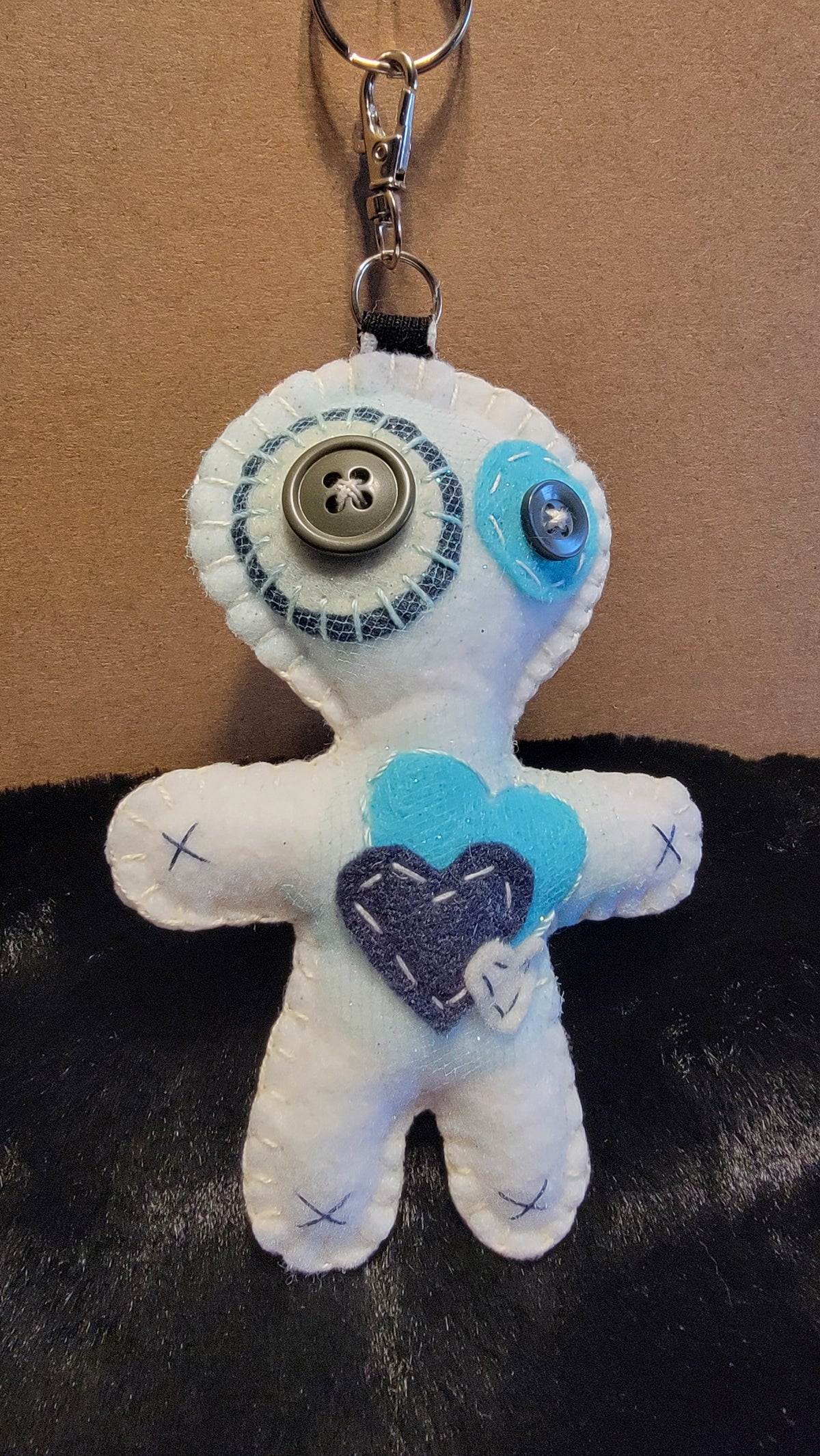 Hand-stitched white Button-Eyed Stitchling bag charm