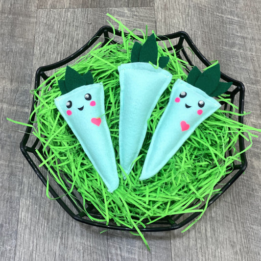 Three mint green carrot-shaped plush with faces in a easter basket 