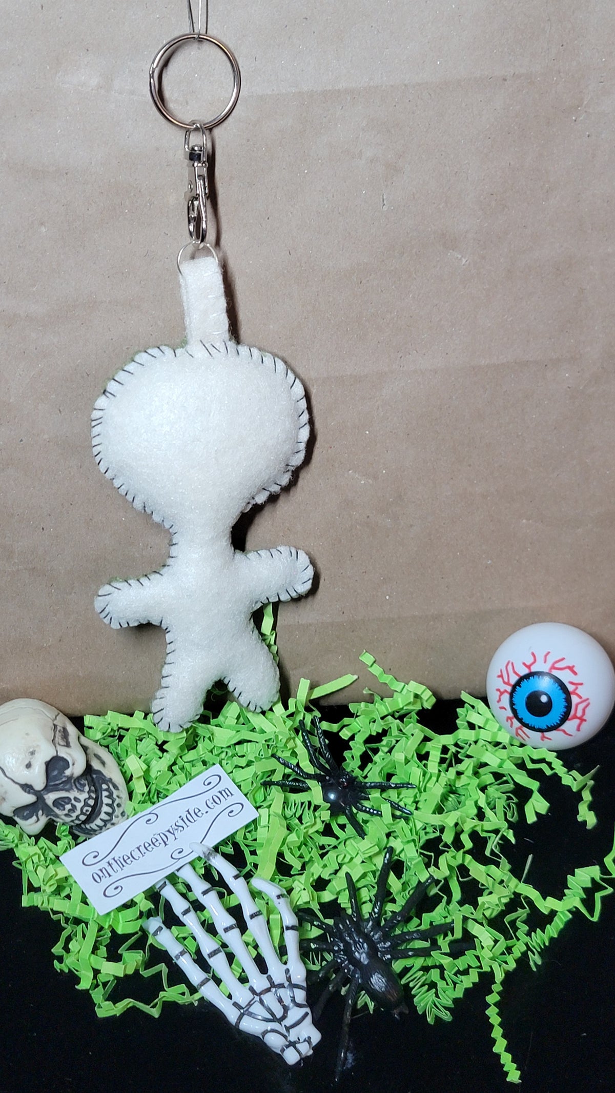 Hand-stitched olive green Mini Button-Eyed Stitchling bag charm with button eyes