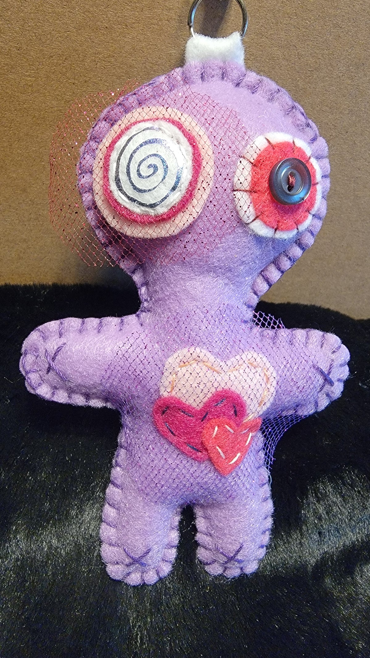One-of-a-kind purple Button-Eyed Stitchling felt bag charm